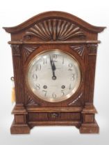 A carved oak eight day bracket clock, with silvered dial signed Curtis and Horspool, Leicester,