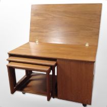 A 20th-century McIntosh teak fold-over top coffee table containing two further nesting tables,
