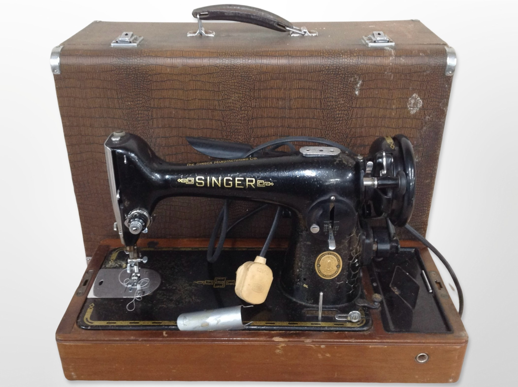 A Singer electric sewing machine in case