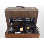 A Singer electric sewing machine in case