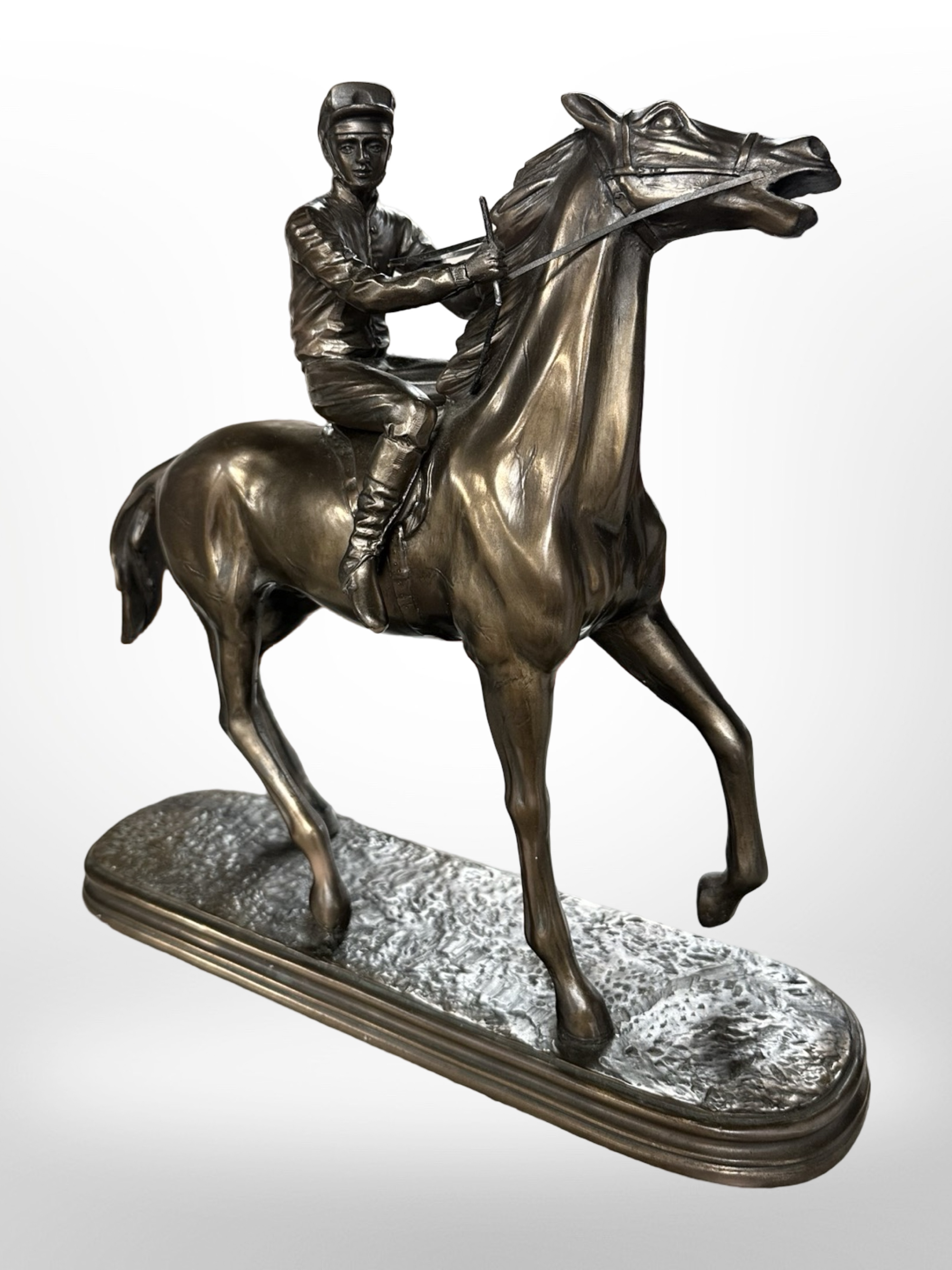 An Oliver Tupton bronzed resin figure of a jockey on horseback, height 28cm.