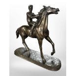 An Oliver Tupton bronzed resin figure of a jockey on horseback, height 28cm.