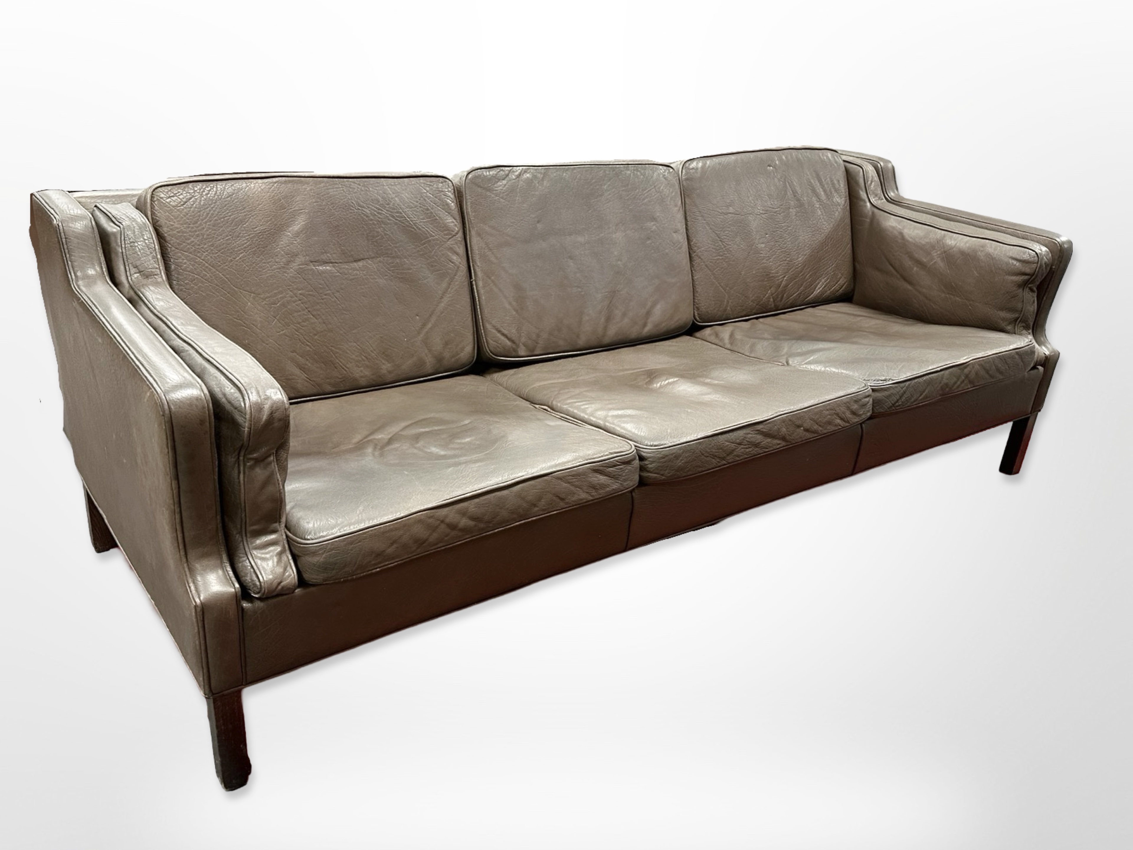 A late 20th-century Danish dark brown leather three-seater settee,