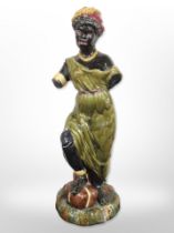 A majolica Blackamoor style figure, height 64 cm and a further torso sculpture,