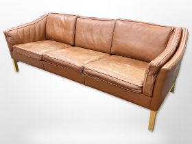 A late 20th-century Danish terracotta leather three-seater settee, length 220cm x depth 80cm x 70cm.