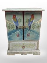 A small double-door cabinet hand-painted with exotic birds, height 31cm.