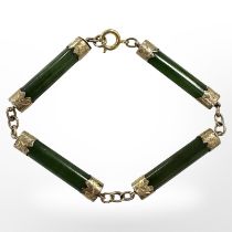 A gold-mounted jadeite bracelet, length 19.