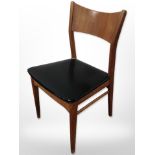 A 20th-century Danish teak and black vinyl dining chair with laminated back rest.