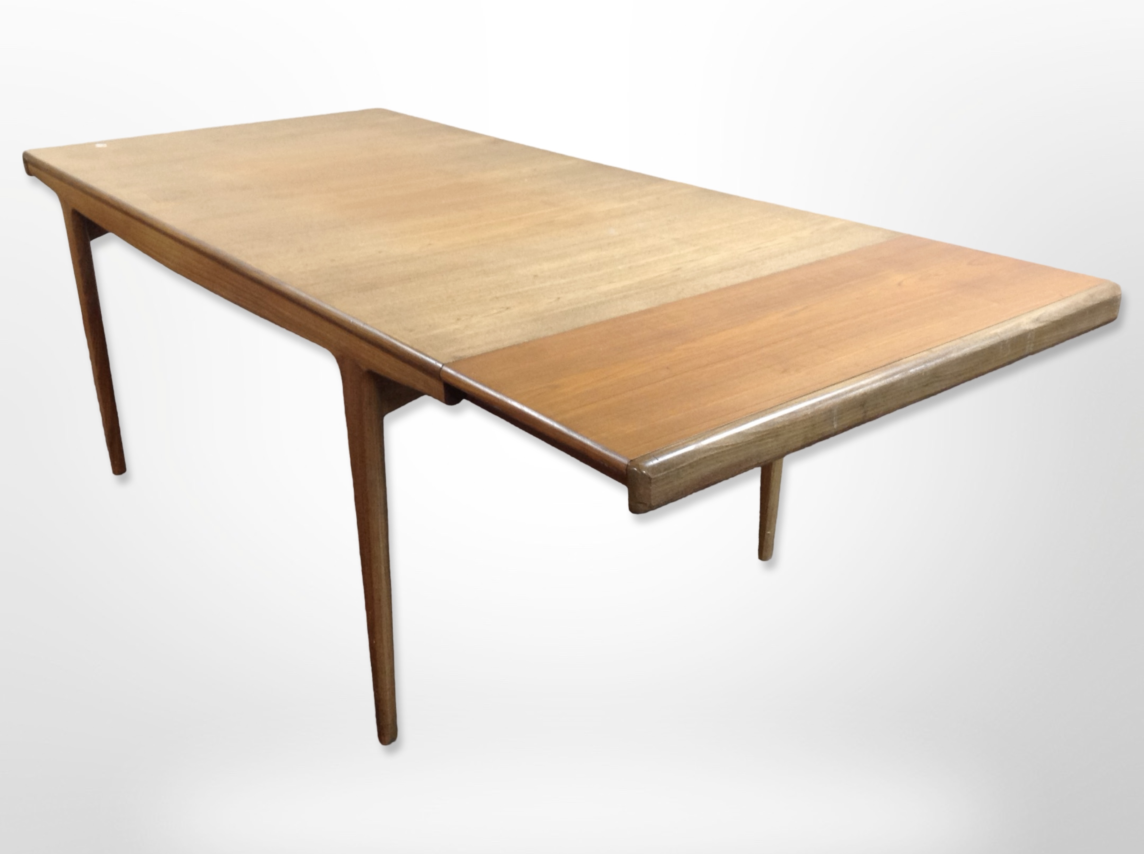 A 20th-century teak pull-out extending rectangular dining table on tapered legs,