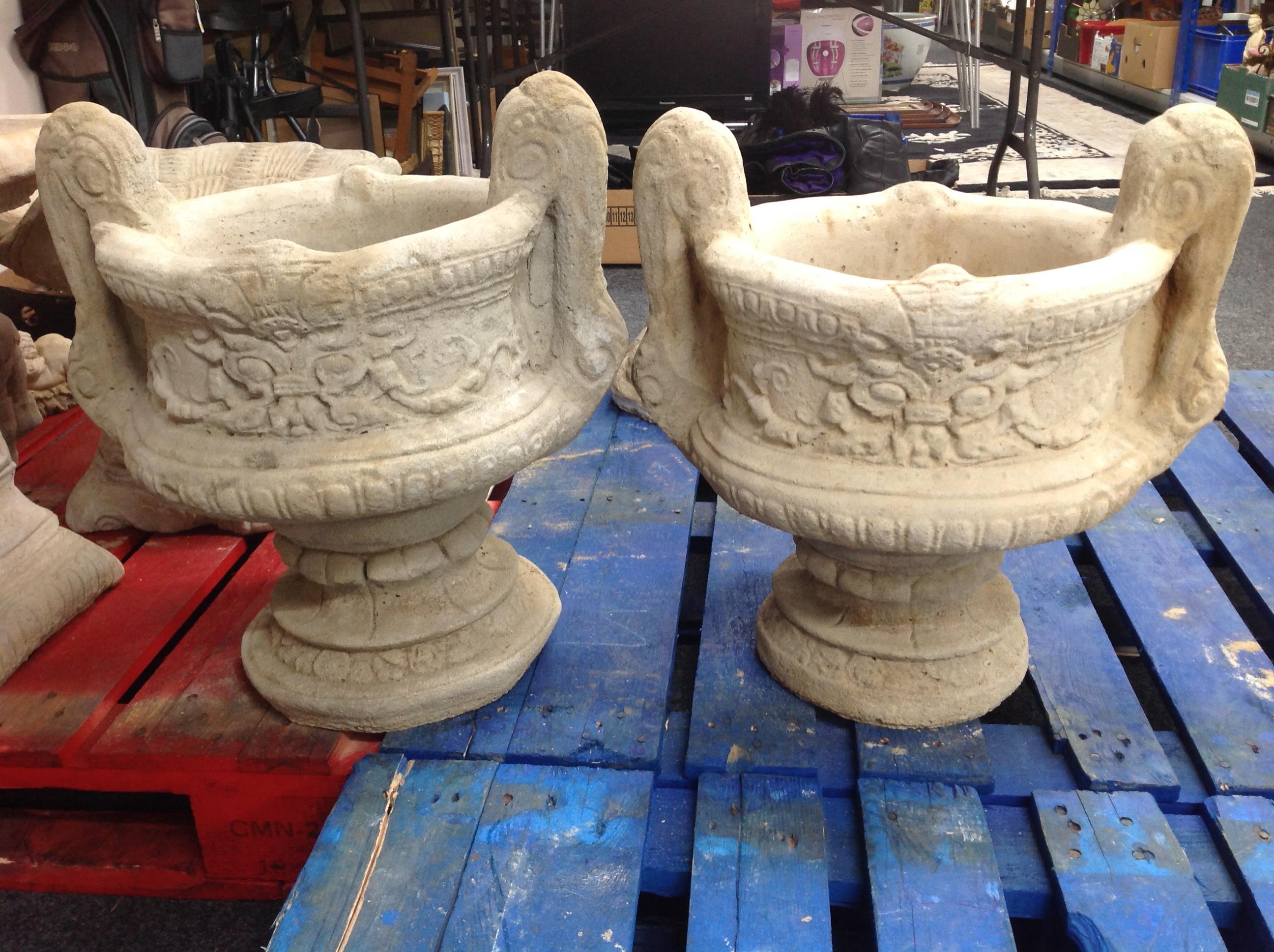 A pair of concrete twin-handled urns,