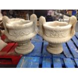 A pair of concrete twin-handled urns,