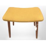 A 20th-century Danish teak footstool in mustard upholstery, width 48cm.