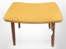 A 20th-century Danish teak footstool in mustard upholstery, width 48cm.