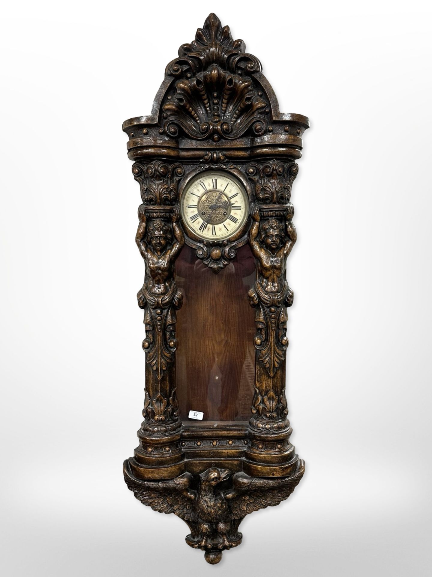 An impressive Victorian-style carved wall clock, length 145cm.