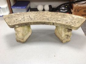 A weathered concrete twin-pedestal garden bench, width 143cm.