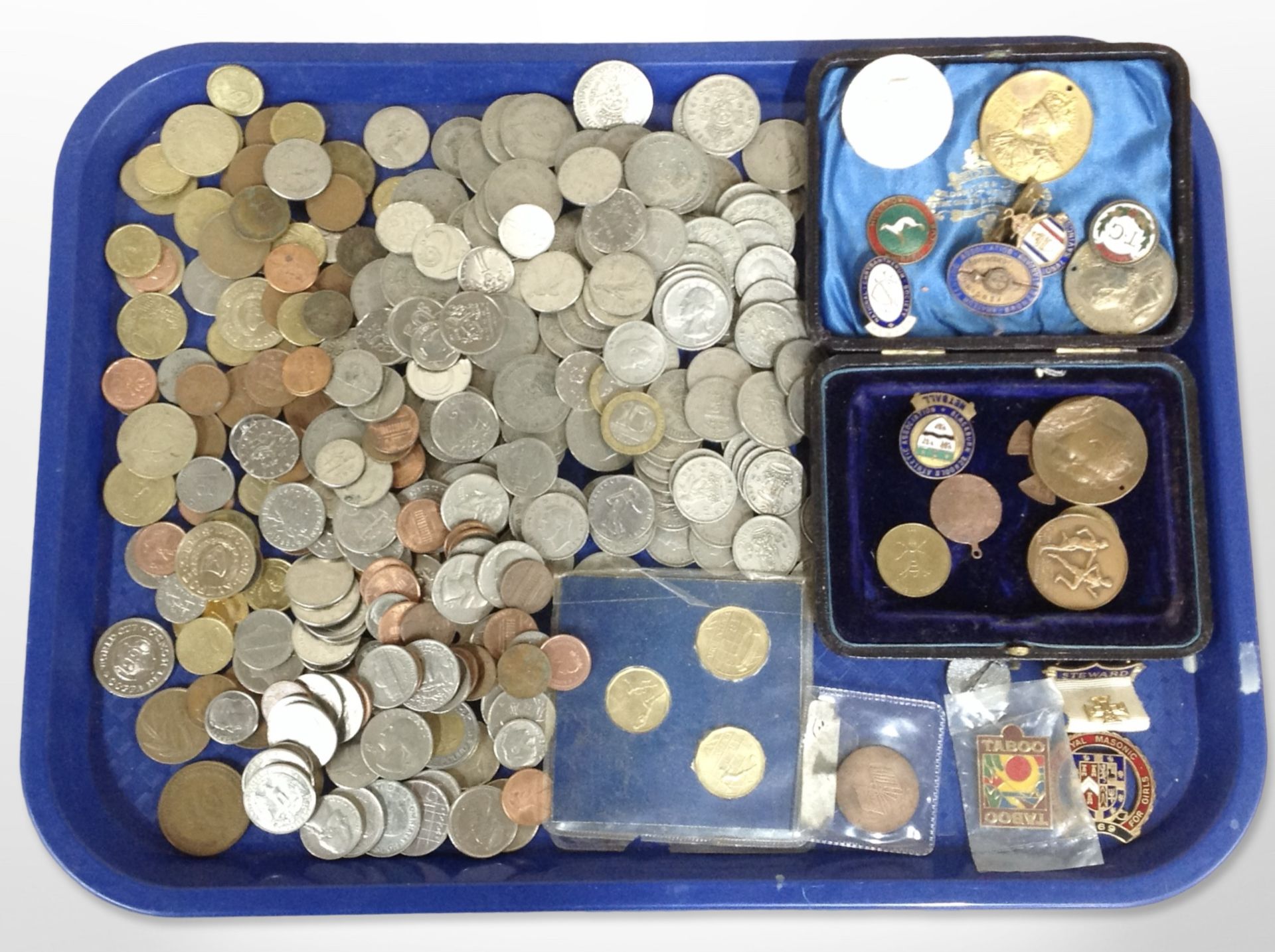 A collection of British pre-decimal coins and foreign coins, enamelled badges, coronation medals,
