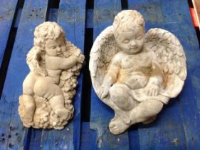 Two concrete cherub garden figures,
