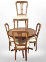 A reproduction circular extending dining table with internal leaf, diameter 98cm (unextended),