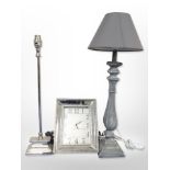 A contemporary wall clock and two lamp bases.