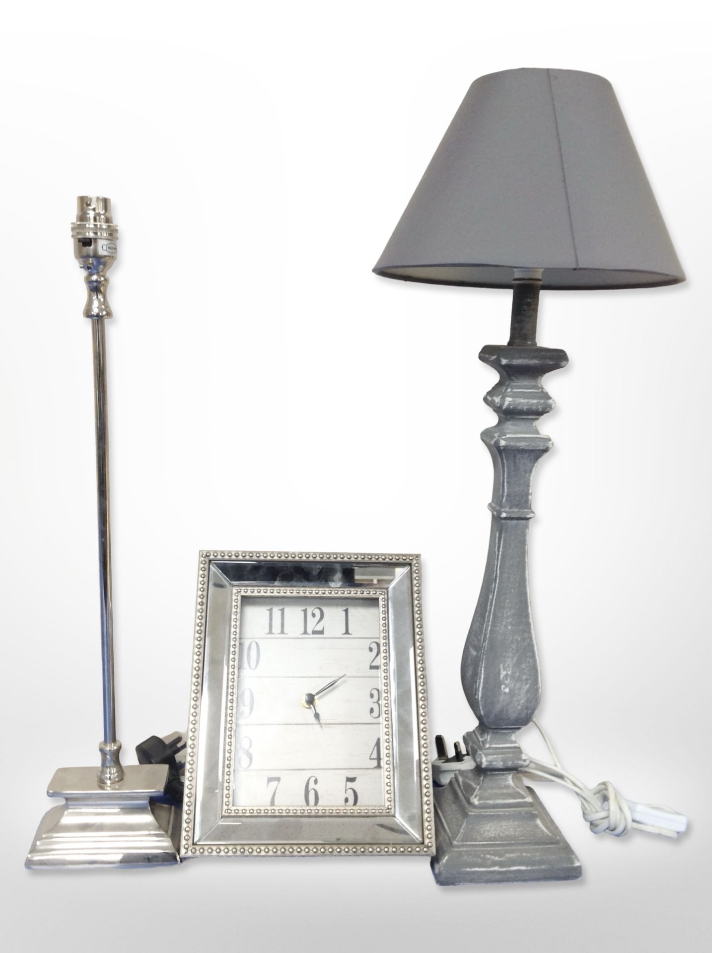 A contemporary wall clock and two lamp bases.