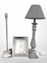 A contemporary wall clock and two lamp bases.