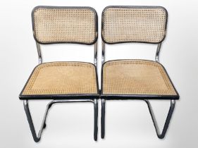 A pair of chrome-framed ebonised cantilever chairs with bergere seats.