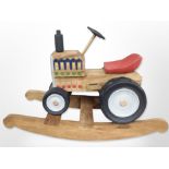 A child's painted wooden rocking tractor seat