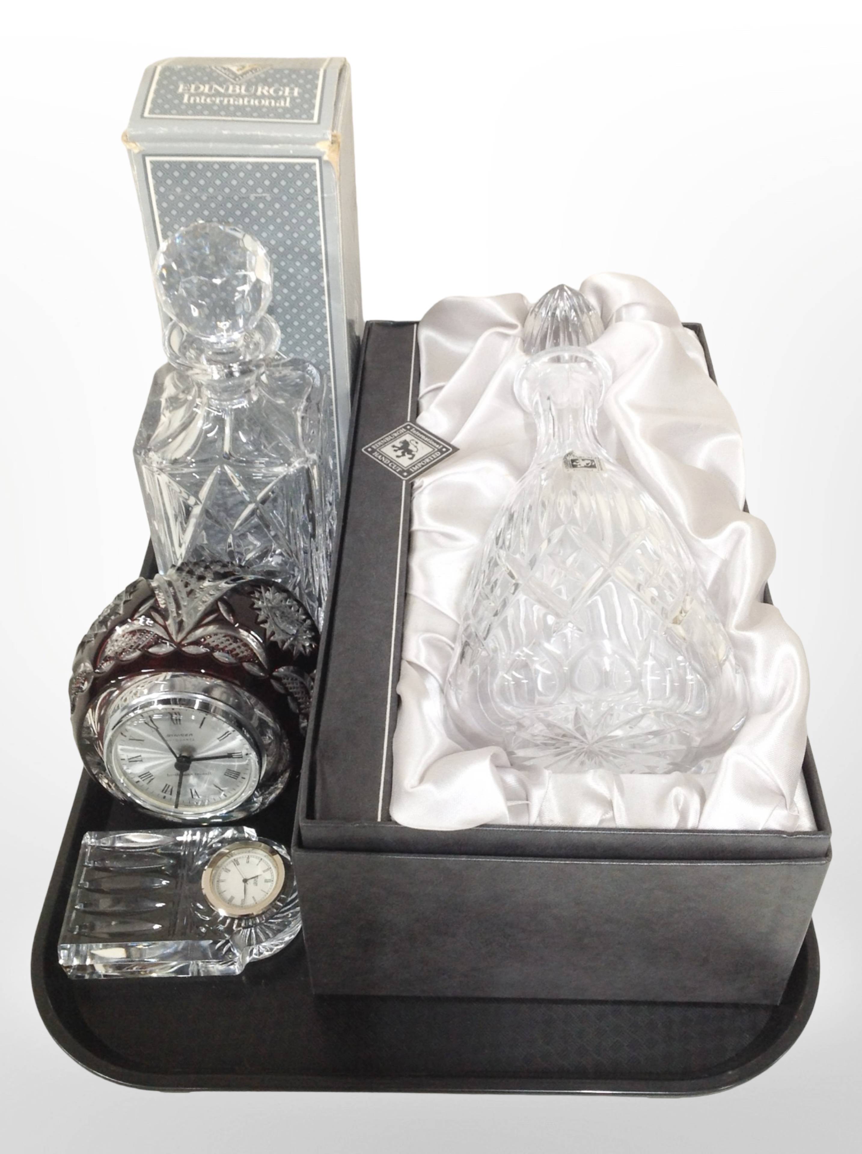 Two boxed Edinburgh Crystal decanter, a Staigen ruby-glass quartz mantel timepiece,