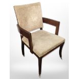 An early 20th-century mahogany-framed armchair on brass castors, width 65cm.