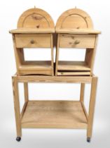 A pine two-tier trolley on castors, width 78cm, and a pair of bedside stands.