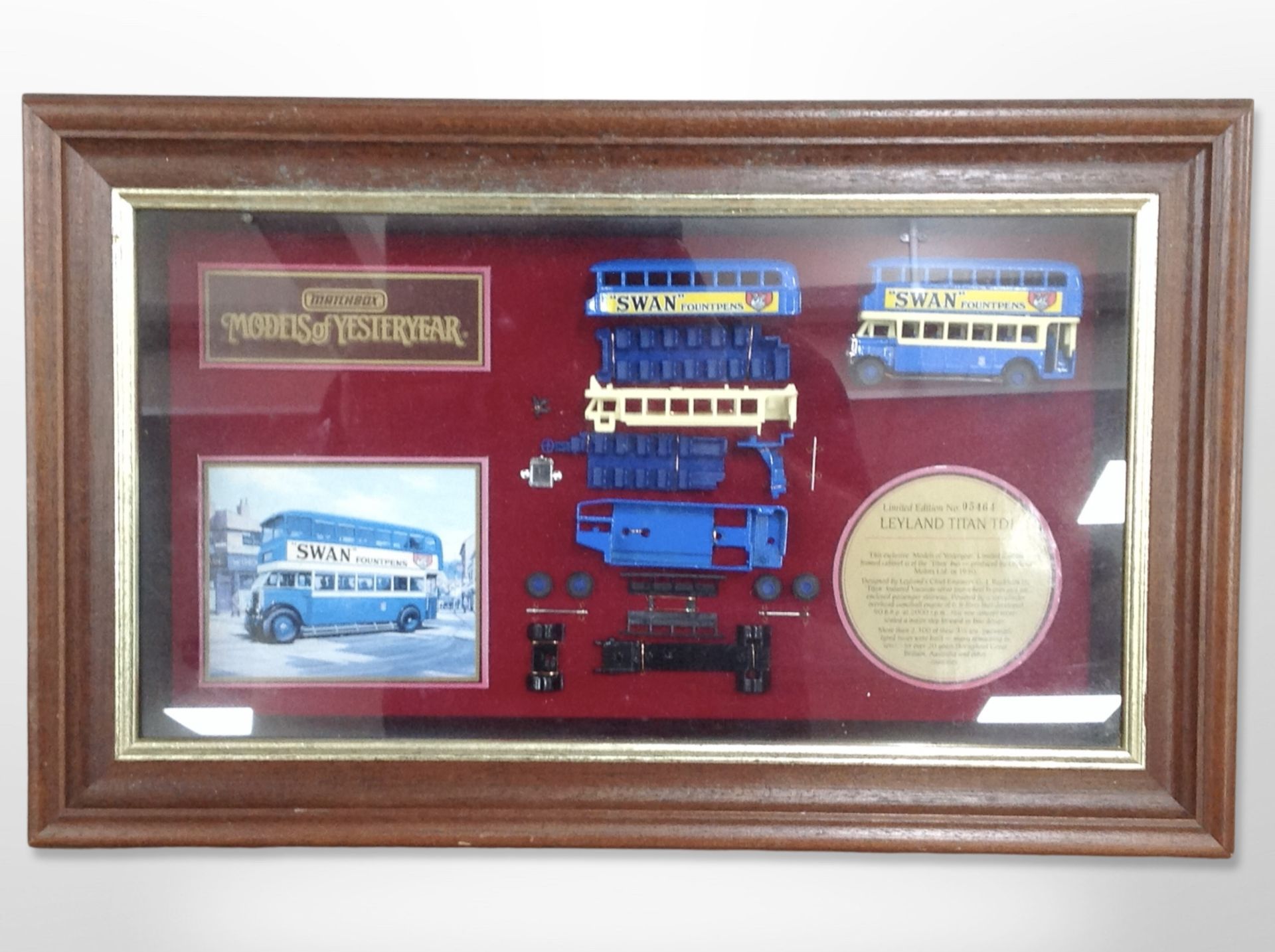 A Matchbox bus montage in glazed display case, 53cm x 33cm.