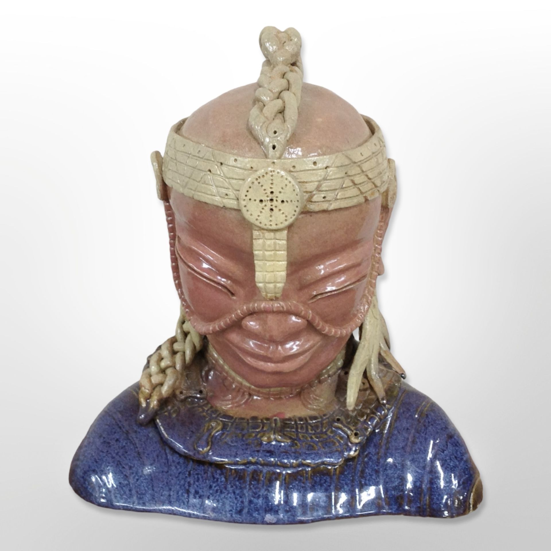 An oriental glazed earthenware bust, height 33cm.