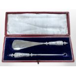 A silver mounted shoe horn and hook in fitted case, Birmingham 1898.