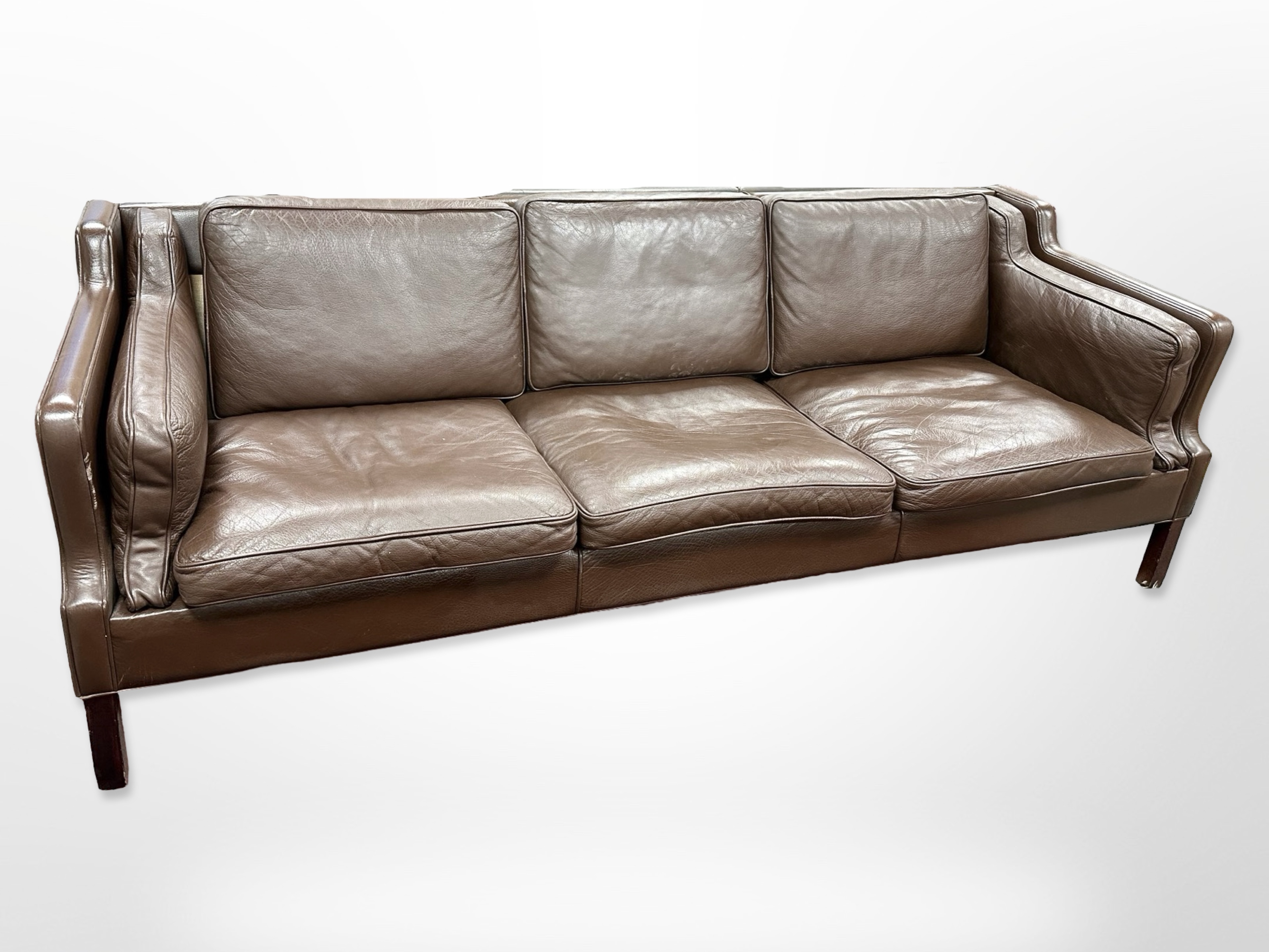 A late 20th-century Danish chocolate brown leather three-seater settee,