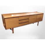 A 20th-century teak low sideboard fitted three cupboards and three drawers,