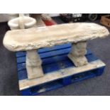 A rustic concrete garden bench on squirrel pedestal,