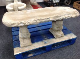 A rustic concrete garden bench on squirrel pedestal,