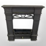 A cast-iron fire insert, 64cm wide x 67cm high.