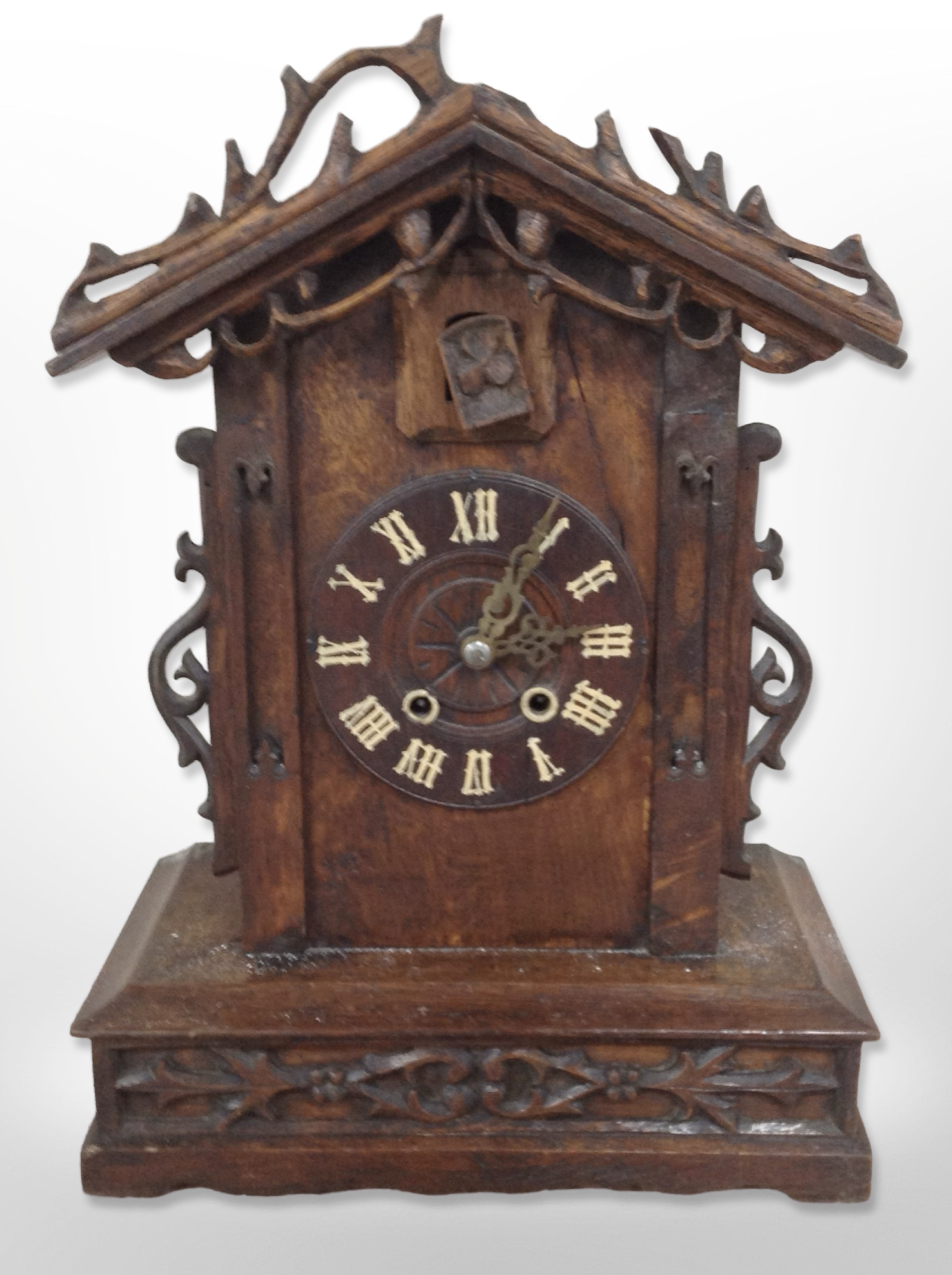 A 19th-century Black Forest carved oak cuckoo clock, height 49cm.