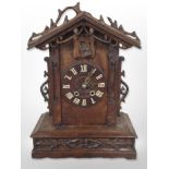 A 19th-century Black Forest carved oak cuckoo clock, height 49cm.