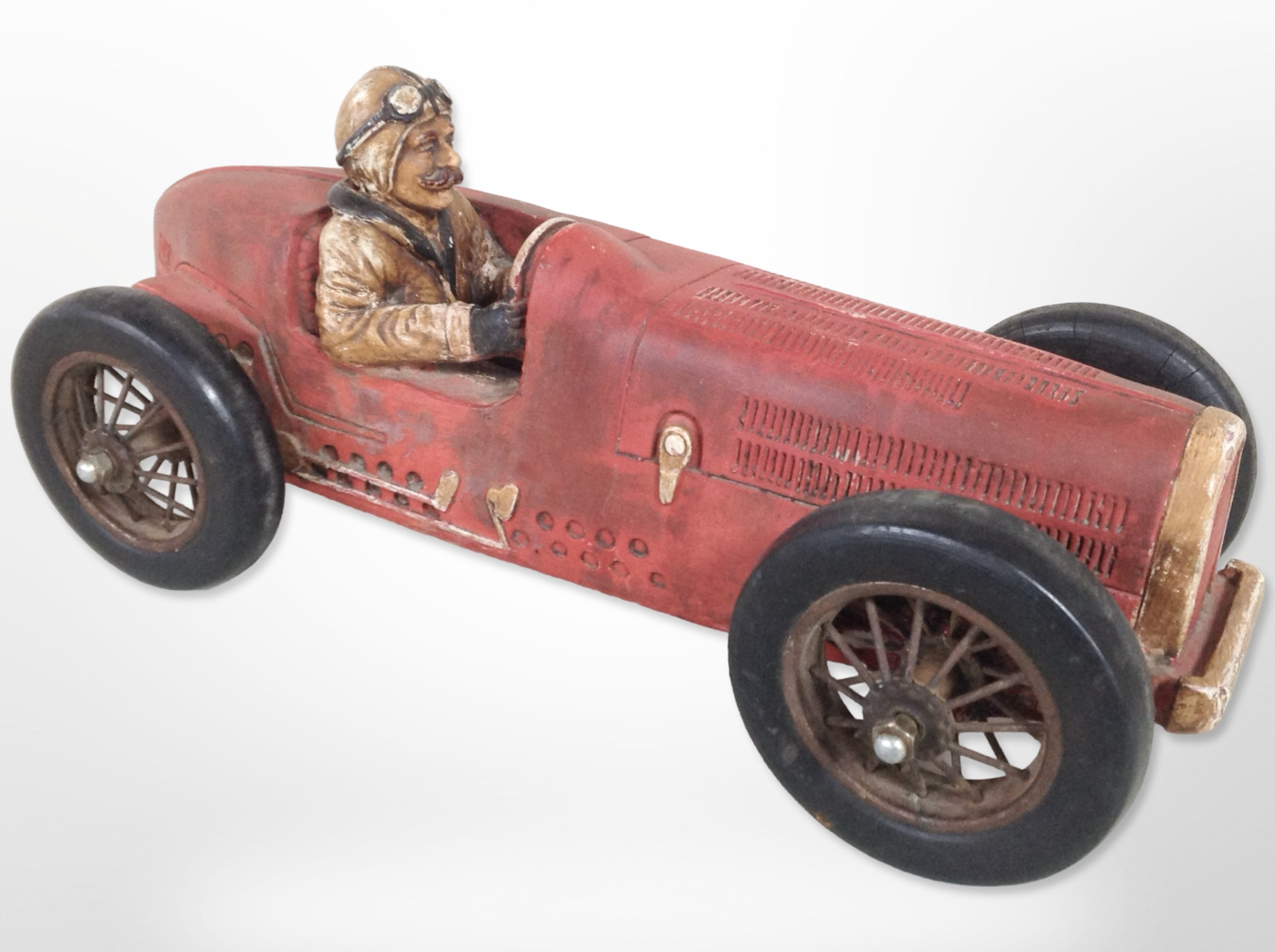 A painted model of a vintage motor car,