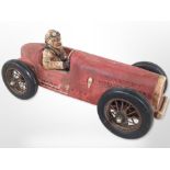 A painted model of a vintage motor car,