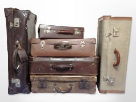 Six vintage leather and canvas luggage cases.