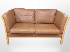 A late-20th century Danish brown stitched leather two-seater settee, with beech frame,