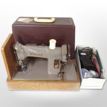 A Singer electric sewing machine with lead and pedal