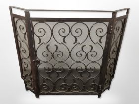 A metal fire screen with hinged central door, width 103cm.