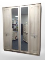 A pine-effect mirrored wardrobe, 153cm wide x 53cm deep x 189cm high.