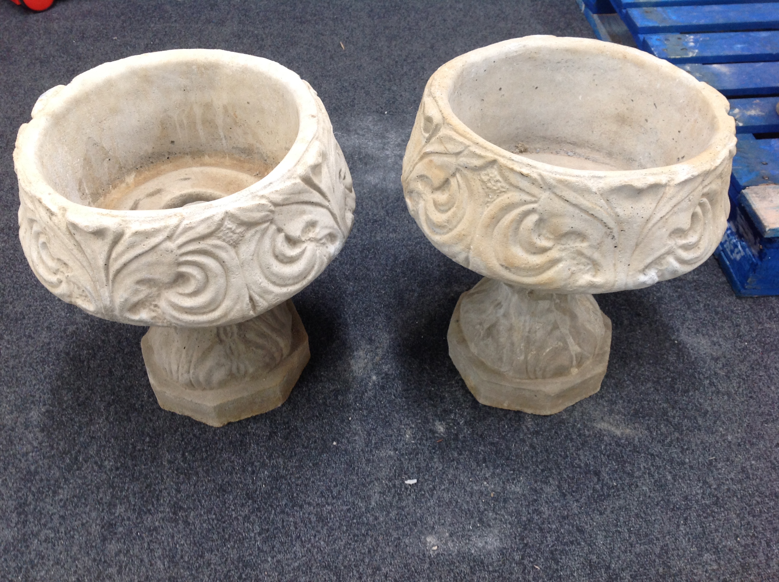 A pair of concrete acanthus leaf urns,