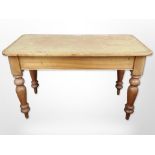 An early-20th-century pine rectangular table with tooled leather-inset writing surface,
