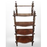 A Victorian mahogany five-tier serpentine-front whatnot stand, 136cm high.